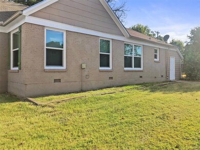 View of side of home with a yard
