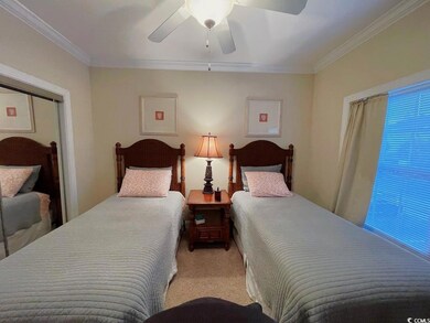 Bedroom with multiple windows, ornamental molding,
