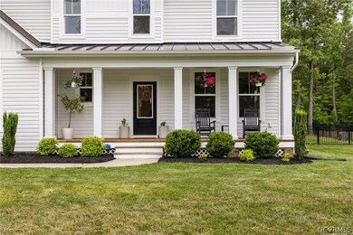 Doorway to property featuring covered porch and a