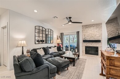 Living area with ceiling fan, a fireplace, and rec