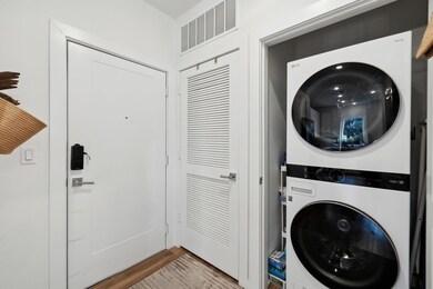 Washroom featuring stacked washing machine and dr