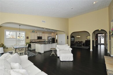 Great Room w/beautiful hardwoods looking toward Kitchen & Dining Room.