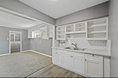 This kitchen is fully refreshed with newer cabinetry, granite, and flooring.