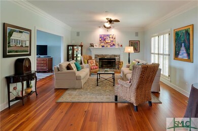 The formal living room features a gas fireplace wi
