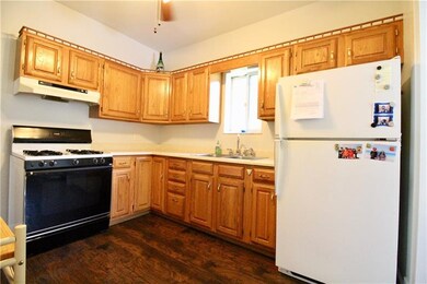 Kitchen View With Hardwood Cabinets & New Wood Sty