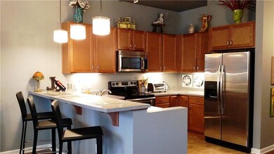 Open & bright kitchen with seating at counter. Sta