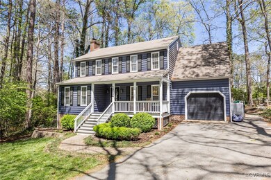 Colonial house featuring an attached garage, a chi