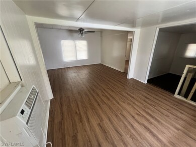 Empty room featuring dark hardwood / wood-style floors and ceiling fan
