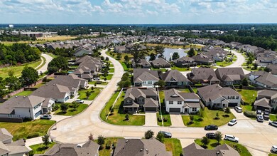 An aerial view of the home showcases its size and ideal location within this charming community. Notice the updated gutters (2021) throughout the exterior.