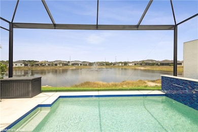 Swimming pool with a water view, a lanai, a residential view, and a patio area
