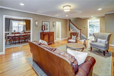 Living room has hw floors, crown molding, sconces 
