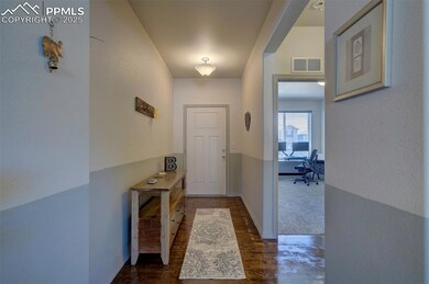 Doorway with an office area, dark wood finished fl