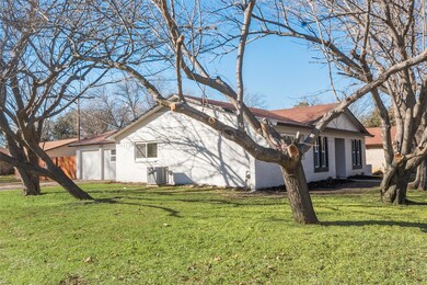 View of property exterior featuring a lawn and cen