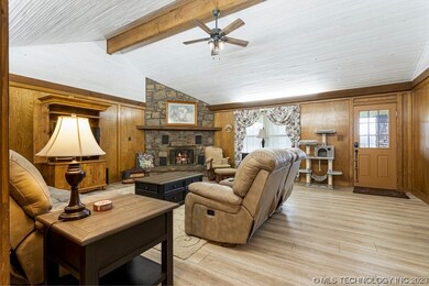 Large living room with vaulted ceiling with beams