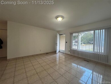 Spare room with light tile patterned flooring and baseboards