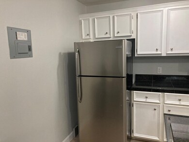 Kitchen featuring white cabinets, freestanding re