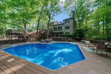 View of swimming pool featuring stairs, a deck, an