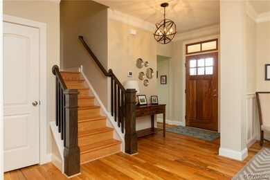 Entry foyer with stairs that are off-set to the si