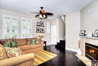 Cozy living room with fireplace and plantation shu