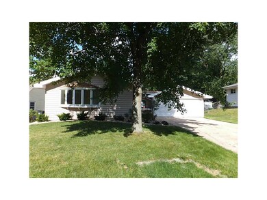 Front Exterior. Large two car garage and mature tr