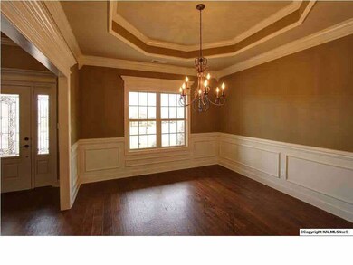 Dining room with trey ceiling, extensive trim, wood flooring, 9 foot ceilings.