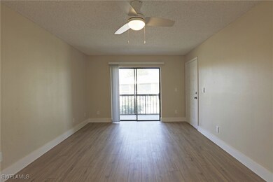 Empty room with a textured ceiling, wood finished