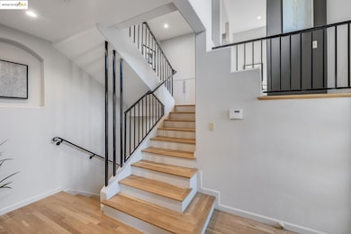 Staircase with wood finished floors and baseboards