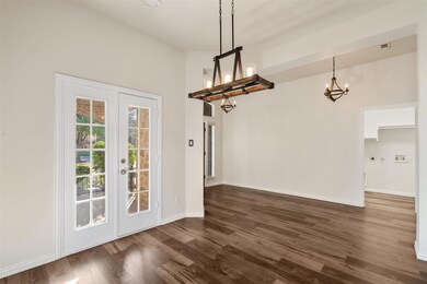 Unfurnished dining area with french doors, dark wo
