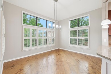 Unfurnished dining area featuring baseboards, lig