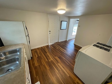 Kitchen featuring freestanding refrigerator, base
