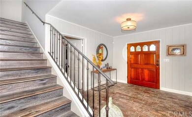 Distressed brick formal entry.  Newer wood stairca