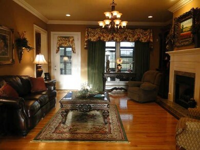 Living room features custom built Cherry built-ins and a gas fireplace. Exquisite light fixtures throughout the home.