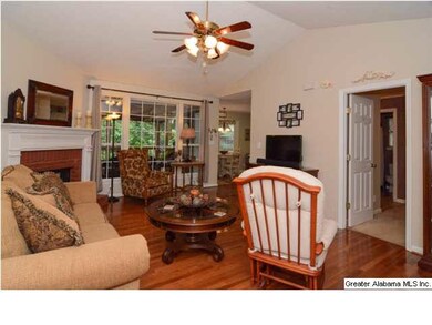 Living room has hardwood floors and a ceiling fan!
