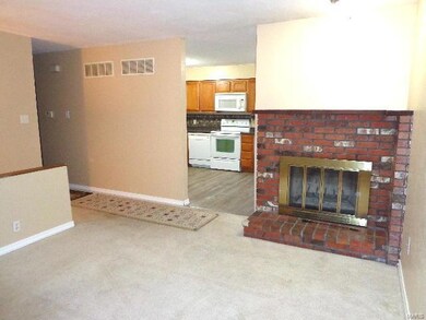 Spacious living room with woodburning fireplace.