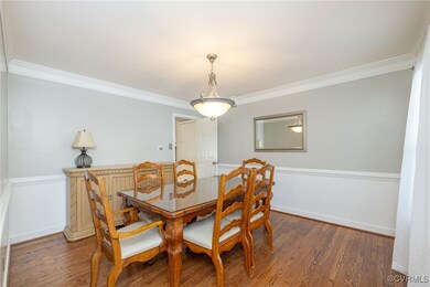 Dining area featuring baseboards, wood finished fl