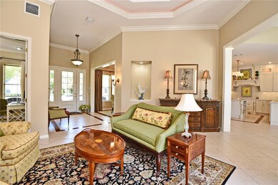 Living Room view with up lighted tray ceiling & cu