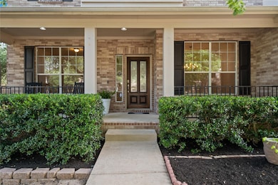 Entrance to property featuring a porch and brick 