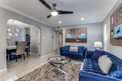 Living room featuring ceiling fan with notable cha