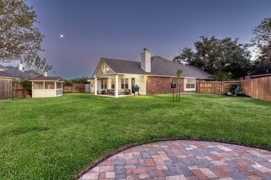 Expansive backyard featuring the covered patio (Dec 2019), fire pit patio, mature trees, and a large grassy area with plenty of room for play or future pool.