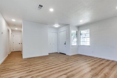 Spare room with light wood-type flooring, visible 