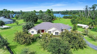 Aerial View Front of Home and Lake Pendravis
