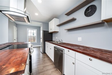 Kitchen featuring wood counters, appliances with s