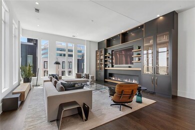 Living room with wood finished floors, a glass cov