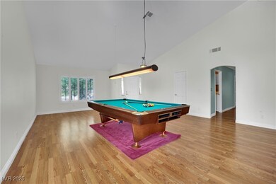 Rec room with high vaulted ceiling, wood finished