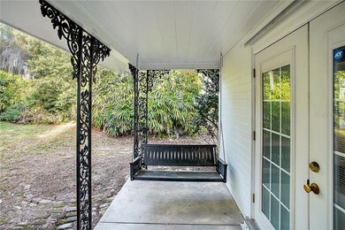 The porch swing graces the covered porch that evok