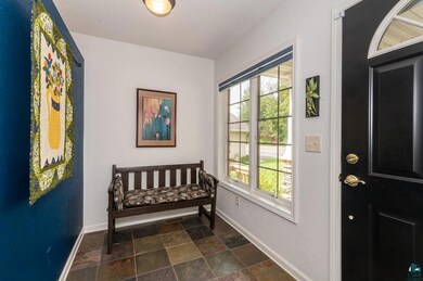 Doorway to outside featuring a textured ceiling an