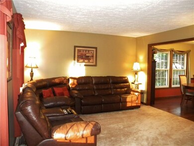 Large living room features a gas fireplace and lea