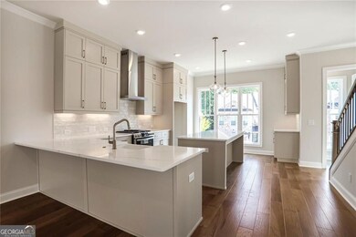 Kitchen featuring wall chimney exhaust hood, a farm sink, an oversized island & breakfast bar