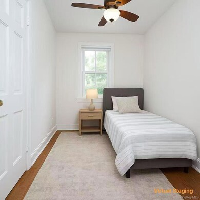 Bedroom with wood finished floors and ceiling fan