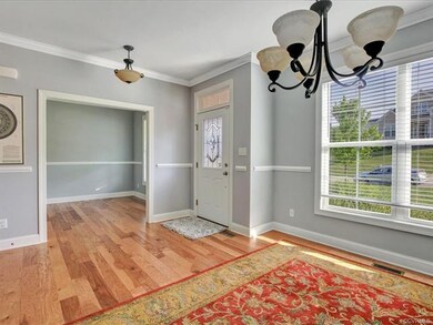 Greet guests in the open foyer showcasing the home